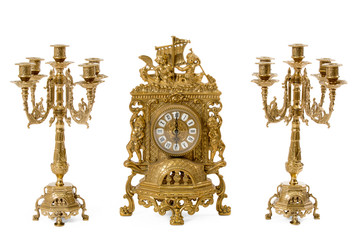 Two vintage gold candle holder and clock on a white background
