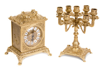 Vintage golden candlestick and clock on a white background