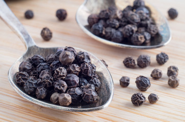 Macro view on the seeds of sweet peas in an old metal spoons