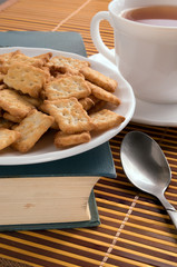 White plate with cookies on the old book