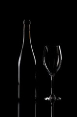 Bottle and vineglass on black background