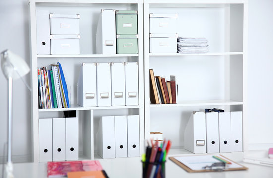 File folders, standing on the shelves at office.