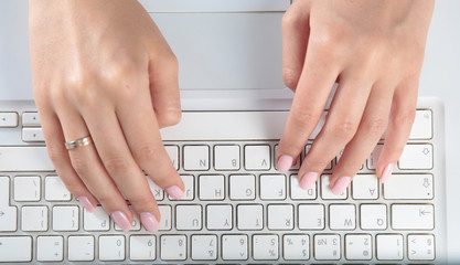 Fototapeta na wymiar Close-up of typing female hands on keyboard