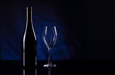 Bottle with vine and empty vineglass