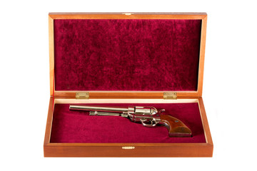 Revolver in gift box on white background