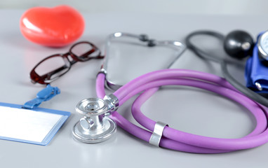 Red heart and a stethoscope on desc