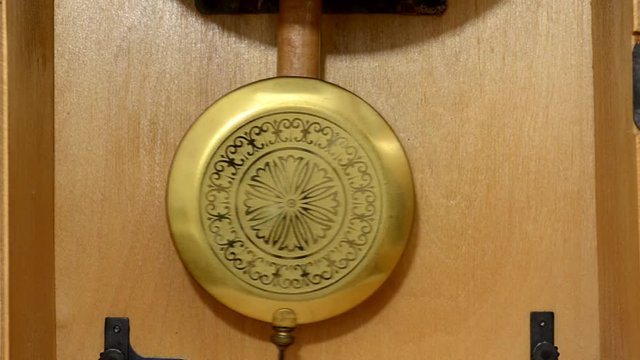 the pendulum wall clock with the battle in the wooden case