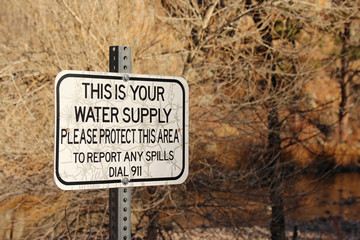 "This is your water supply " sign near river states that the area must be protected.
