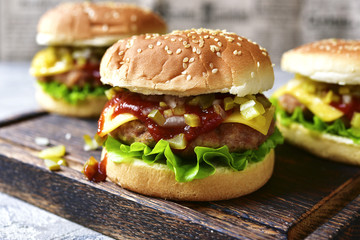 Cheeseburger with meat cutlet and pickled vegetable.