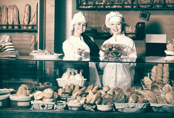 Bakery staff offering bread