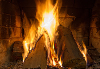 Fire in fireplace. Fire background. Blazing Bonfire. Firewood burns in a fireplac