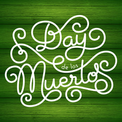 Day de los Muertos hand lettering on green wood background