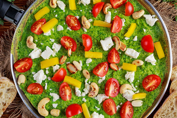 Vegetable Green Omelette with tomatoes, kale, greek cheese, olives, nuts, toast on wooden background. concept healthy food