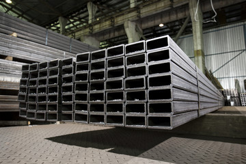 Stainless steel bars and pipes deposited in stacks