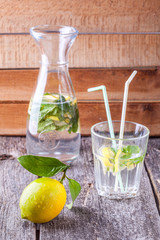 Lemon and lemonade on a wooden background
