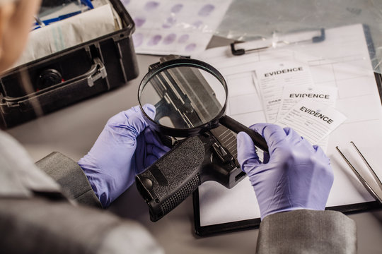 Detective through a magnifying glass looking at a evidence