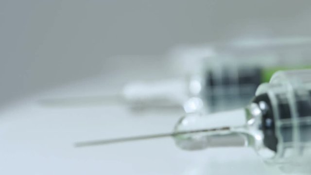 Macro shot of rotating syringes.