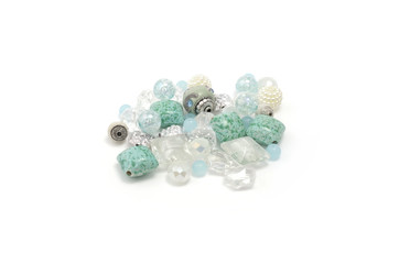 Decorative colorful beads scattered on white background - accessories for handmade and hobby