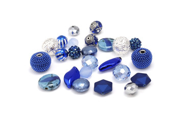 Decorative colorful beads scattered on white background - accessories for handmade and hobby