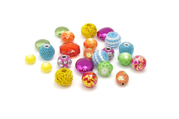 Decorative colorful beads scattered on white background - accessories for handmade and hobby
