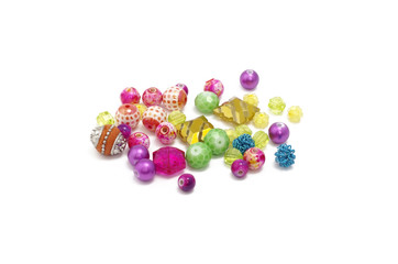 Decorative colorful beads scattered on white background - accessories for handmade and hobby