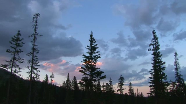 Lightning strikes from building thunderhead cloud in Montana forest, time lapse.