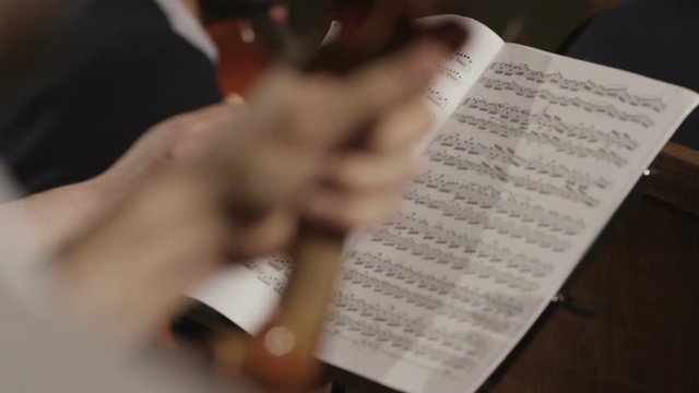 Hand, opening musical note paper sheet. Shot on RED EPIC Cinema Camera in slow motion.