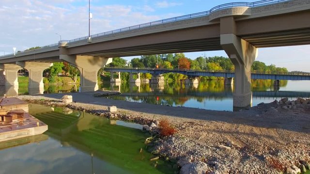 Scenic aerial flyby of two bridges in Wrightstown, WI.  Under the new bridge, then over the old bridge it will replace.