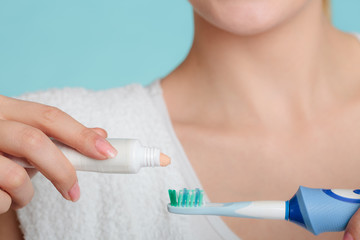 Young girl with toothpaste and toothbrush.