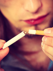 Closeup of man breaking cigarette addiction free