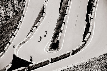 Naklejka premium Famous Passo Dello Stelvio Road in Swiss - Italy border. Favourite place for all bike riders. Alone biker on the top.