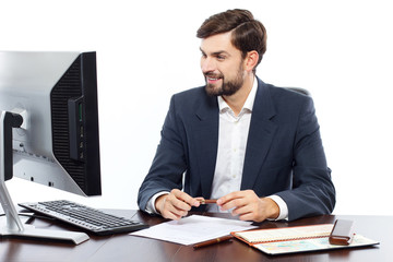 Fototapeta premium Businessman working at his office with computer.