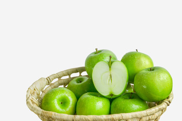 Group of green apples fruit and apple slice in woven basket