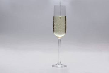 champagne is poured into a glass