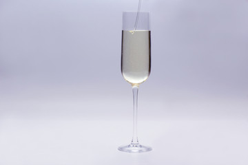 champagne is poured into a glass