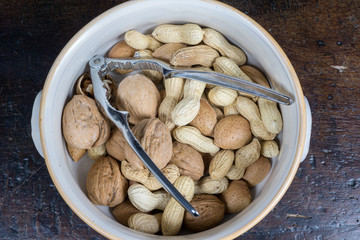 dried fruit, nuts, hazelnuts and almonds on cutting board and antique table