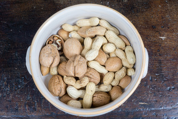 dried fruit, nuts, hazelnuts and almonds on cutting board and antique table