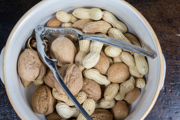 dried fruit, nuts, hazelnuts and almonds on cutting board and antique table