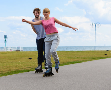 Young couple rollerblading together