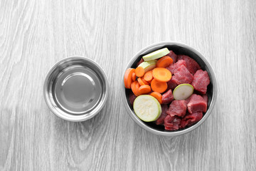 Organic dog food in a bowl on a wooden floor