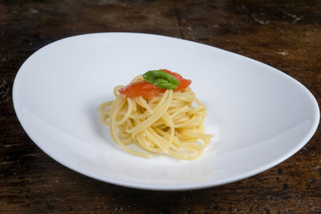 italian spaghetti with tomato and basil in a pot