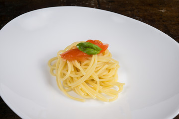 italian spaghetti with tomato and basil in a pot