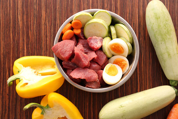 Healthy dog food on wooden background