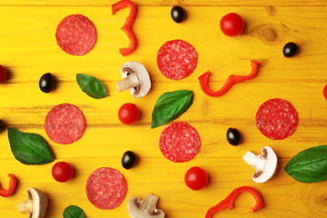 Pizza ingredients on wooden background