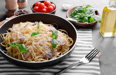 Pasta with mushrooms sauce in pan closeup