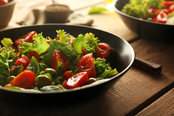Tasty vegetable salad on kitchen table