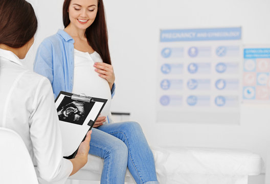 Young pregnant woman visiting gynecologist