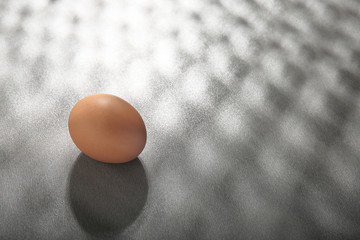 Raw egg on grey background