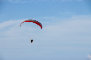 Paramotor flying over the fields in the sky