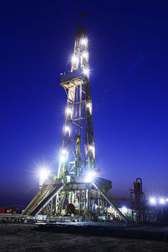 Tall oil derrick, at night